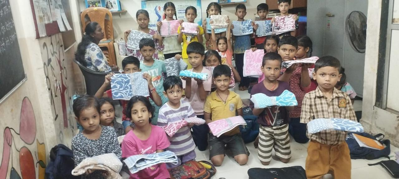 Children displaying their towels at Sona Sarovar Trust