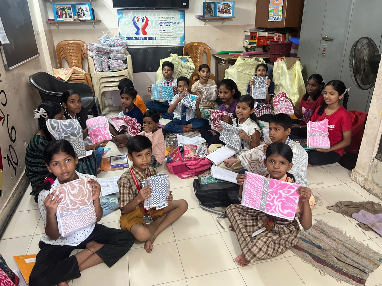 Children at Sona Sarovar Trust holding the towels shared by AuroMira Care Foundation